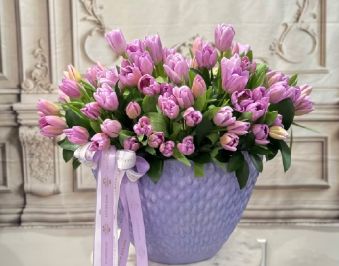 80 lavender tulips in a lavender vase