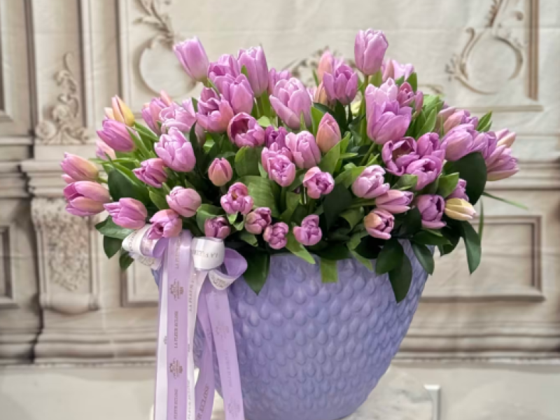 80 lavender tulips in a lavender vase